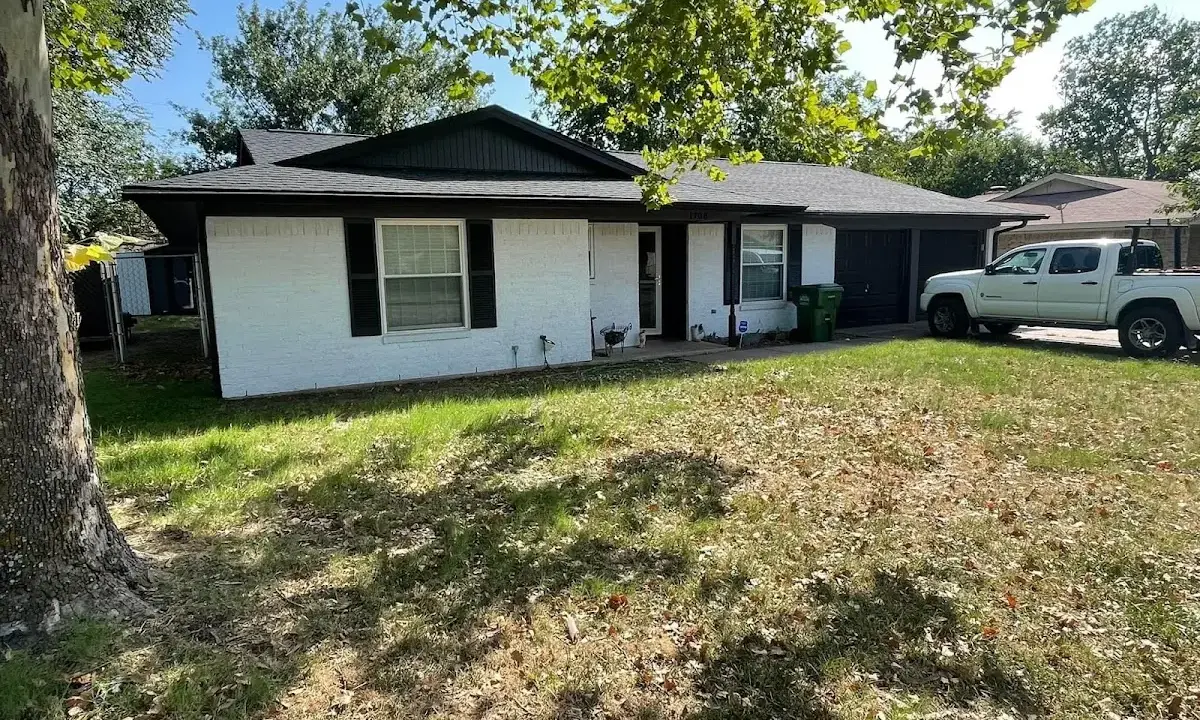 Professional roofing crew working on a residential roof in Farmingdale